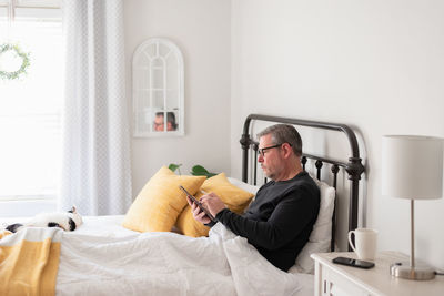 Midsection of man sitting at home