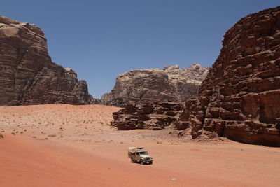 View of desert against clear blue sky