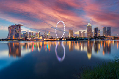 Reflection of buildings in city at waterfront