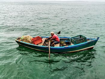 People sitting on boat in sea