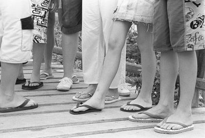 Low section of people standing on footbridge