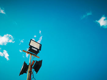 Low angle view of crane against blue sky