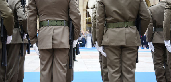 Midsection of soldiers standing outdoors