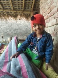 Boy looking away while sitting on floor