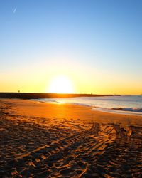 Scenic view of beach against sky during sunset