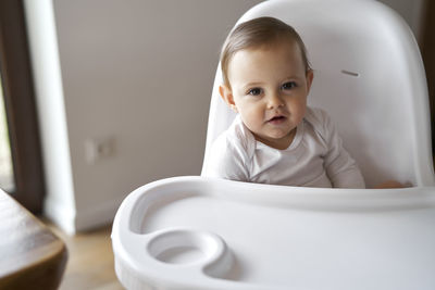 Baby girl sitting on high chair