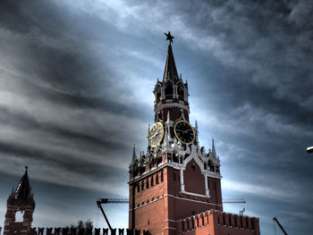 Low angle view of clock tower against cloudy sky