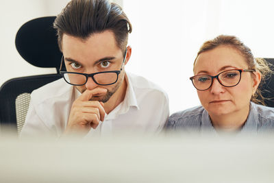 Two business people entrepreneurs working hard sitting at computer screen in office. people at work