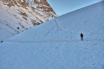 Person walking on snow covered mountain