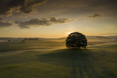 Scenic view of land against sky during sunset