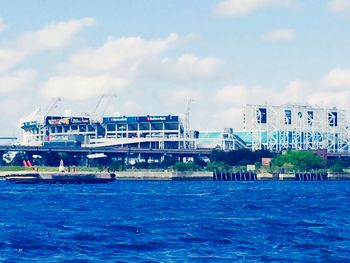 Boats in river with buildings in background