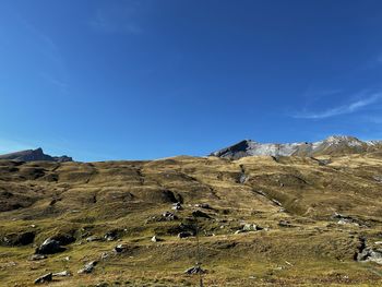 Scenic view of mountains against blue sky