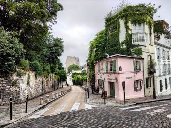 Street amidst buildings against sky