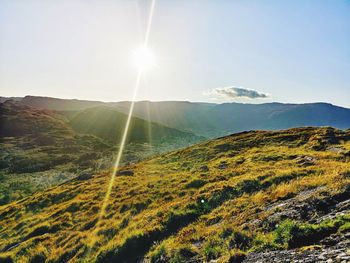 Scenic view of mountains against sky on sunny day