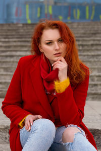 Portrait of a young woman sitting outdoors
