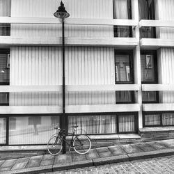 Bicycle parked on street by building