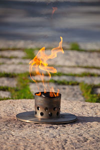 Close-up of burning candles on wood