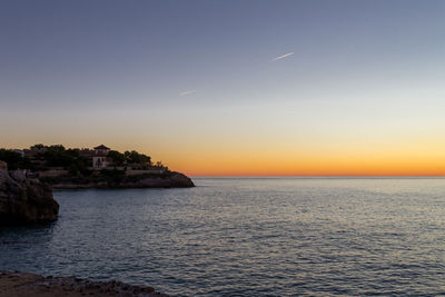 Scenic view of sea against sky at sunset