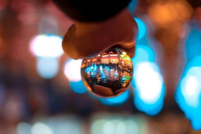 Close-up of hand holding illuminated lighting equipment