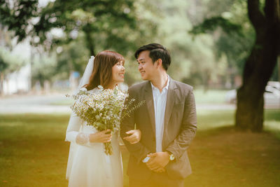 Smiling couple standing arm in arm 