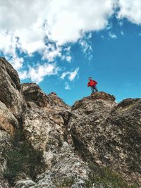 Low angle view of man on mountain against sky