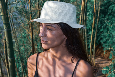 Close-up portrait of young woman wearing hat