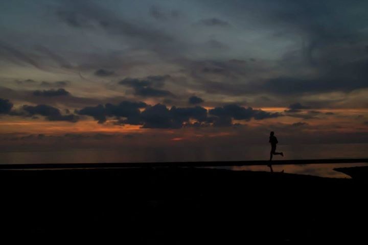 silhouette, sunset, sky, scenics, sea, tranquil scene, beauty in nature, tranquility, horizon over water, cloud - sky, beach, idyllic, nature, water, orange color, one person, cloud, dramatic sky, shore, outline