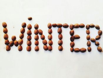 High angle view of coffee beans against white background