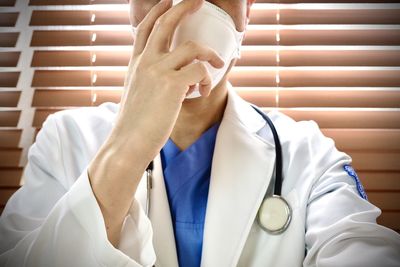 Midsection of man wearing mask