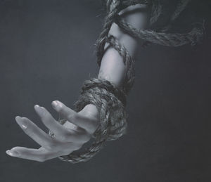 Close-up of hands against black background