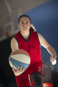 Portrait of woman holding basketball ball 
