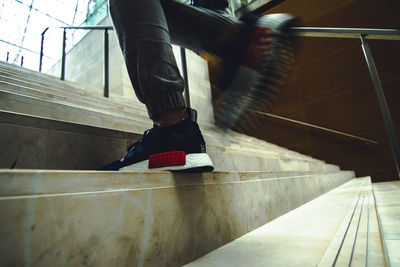 Woman standing on escalator