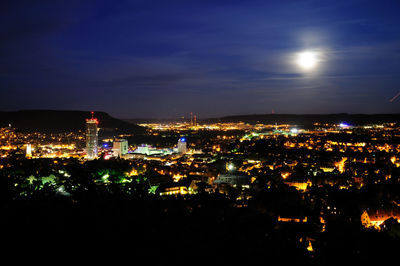 Illuminated cityscape against sky at night