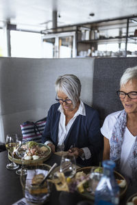 Senior women having meal in restaurant