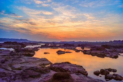 Scenic view of rocks against sky during sunset