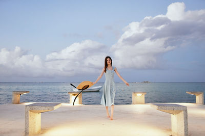 Woman on beach against sky