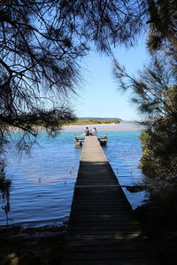 Pier over lake against sky