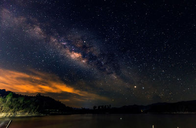 Scenic view of lake against sky at night