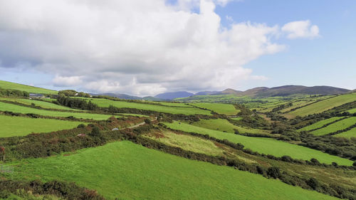 Panoramic view of agricultural field against sky