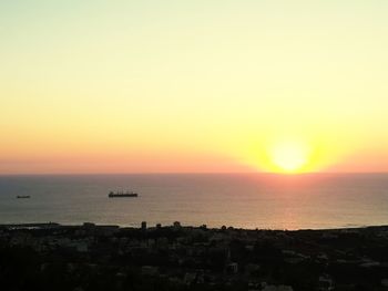 Scenic view of sea against orange sky