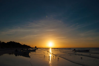 Scenic view of beach against sky during sunset