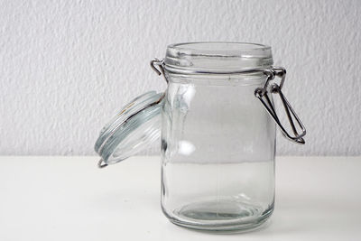 Close-up of jar against wall on table