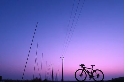 Low angle view of silhouette bicycle against clear sky