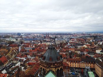 Cityscape against cloudy sky