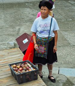 Full length of woman holding ice cream standing outdoors