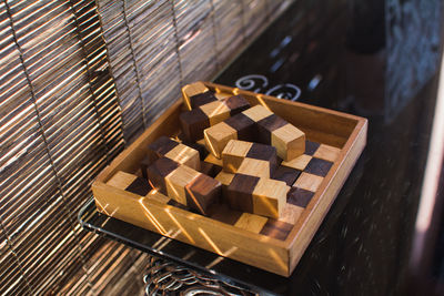 High angle view of wooden blocks in container on table