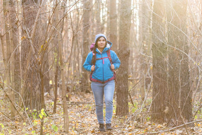 Full length of girl standing in forest