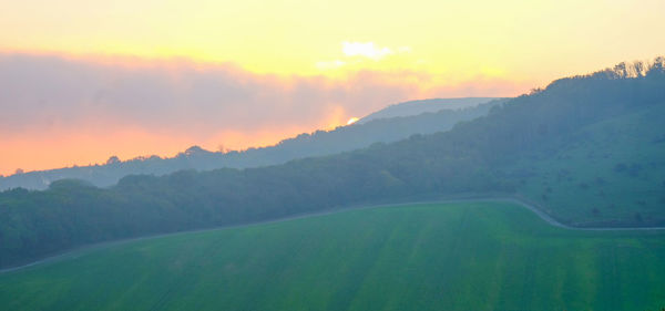 Scenic view of landscape against sky during sunset