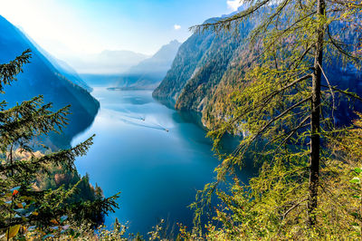 Scenic view of lake and mountains against blue sky