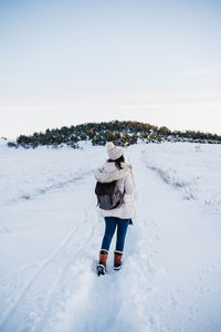 Man standing on snow covered land